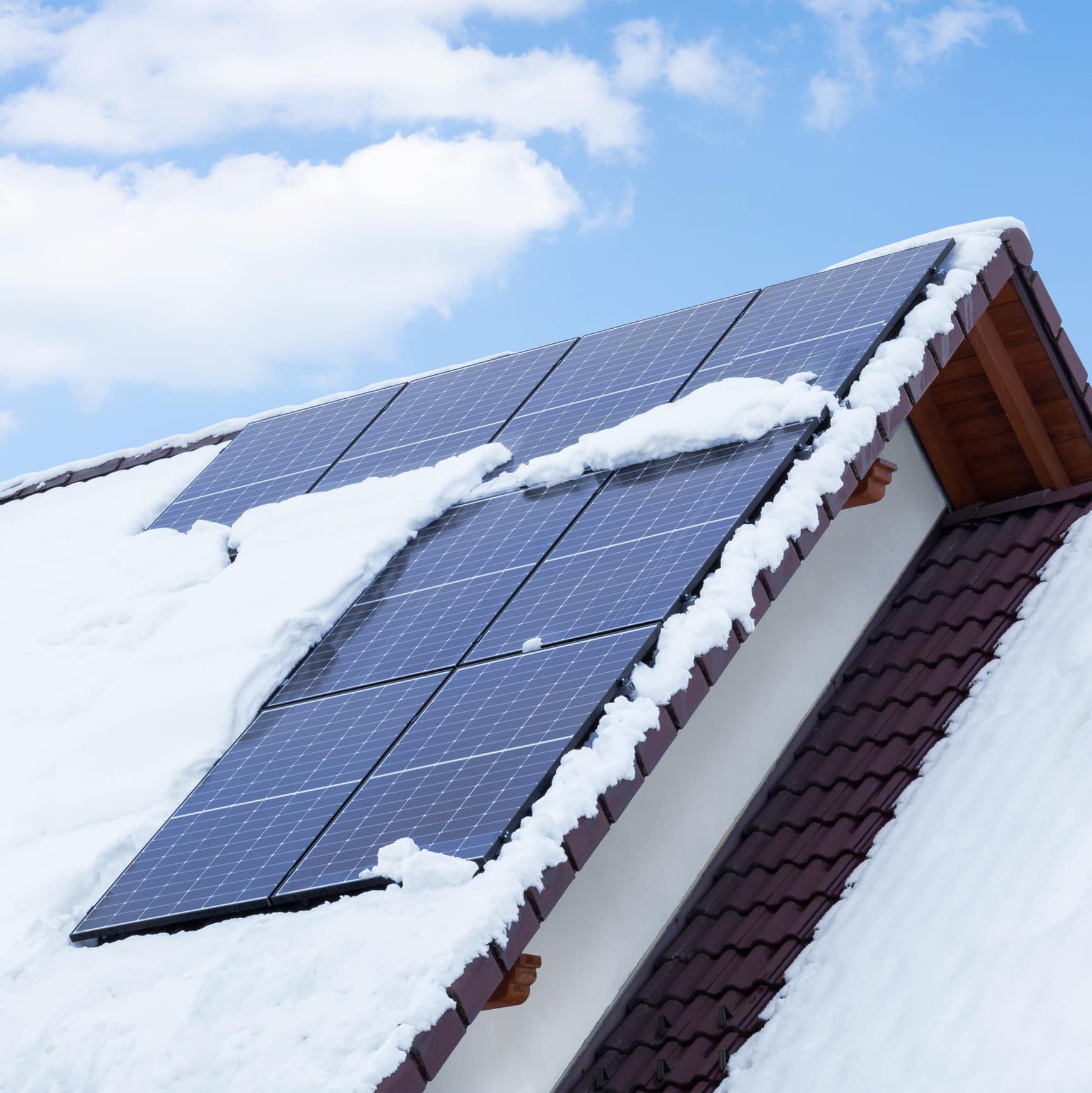 A solar panel on a home, clear of snow and working efficiently during the winter.