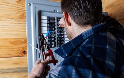 Electrician Installing Wiring In A Residential Electrical Panel During A Home Electrical Panel Upgrade.